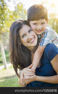 Attractive Young Mixed Race Mother and Son Hug Outdoors in the Park.