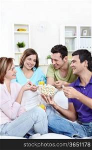 Attractive young people eating popcorn