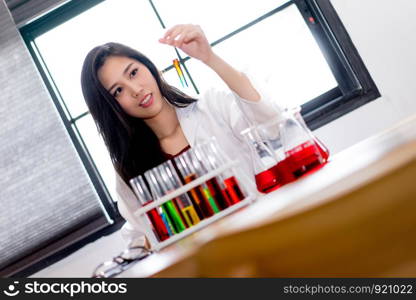 Attractive young scientist researching in laboratory. Healthcare and biotechnology concept.