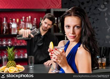Attractive young woman at cocktail bar enjoy drink from bartender