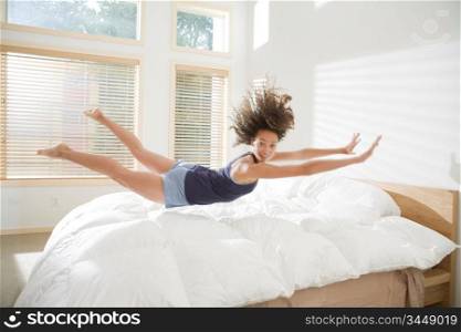 Attractive Young Woman Doing Belly Flop on Bed