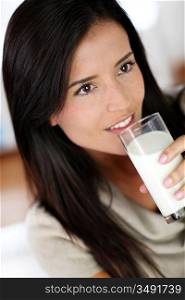 Attractive young woman drinking fresh milk