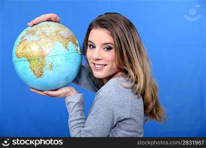 Attractive young woman holding a globe