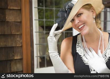 Attractive Young Woman in Twenties Outfit on Porch of an Antique House.