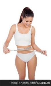 Attractive young woman in underwear with a tape measure isolated on a white background
