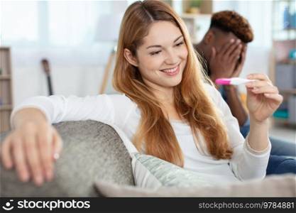 attractive young woman looking at pregnancy test