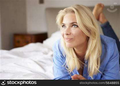 Attractive Young Woman Lying On Bed