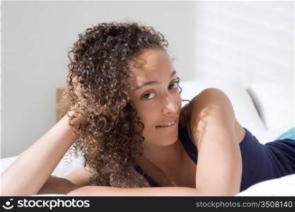 Attractive Young Woman Reclining on Bed