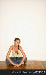 Attractive Young Woman Smiling and Sitting on the Floor