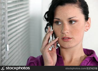 Attractive young woman talking on her mobile phone