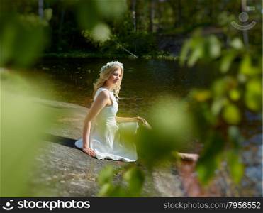 Attractive young woman wearing white summer dress, sunny summer day