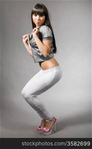 attractive young woman with black hair and white leggings