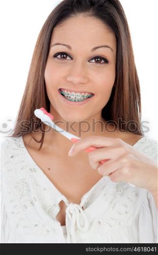 Attractive young woman with brackets cleaning her teeth isolated on a white backgroung