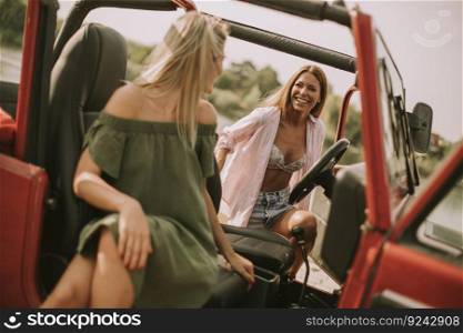 Attractive young women having fun in a convertib≤car