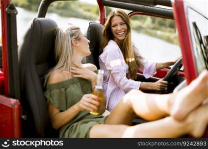 Attractive young women having fun in a convertible car