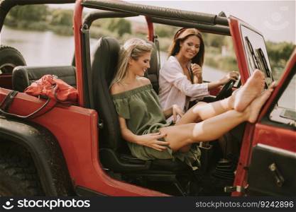 Attractive young women having fun in a convertible car
