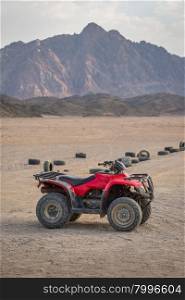 ATV Quad Bike in the desert and background beautiful stone mountain.