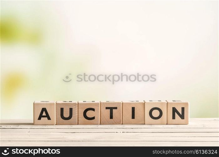 Auction sign on a vintage table on green background