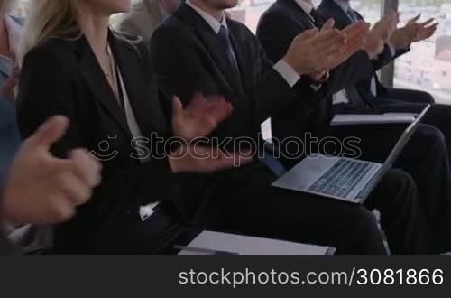Audience applauding at a business seminar