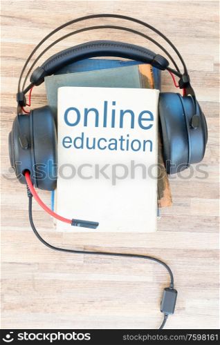 Audio book concept. Headphones and books on wooden table. Top view with copy space.. Audio book concept