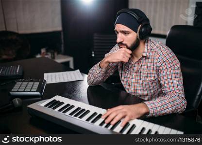 Audio engineering, soundman work with synthesizer in studio. Professional digital sound recording technology. Audio engineering, soundman work with synthesizer