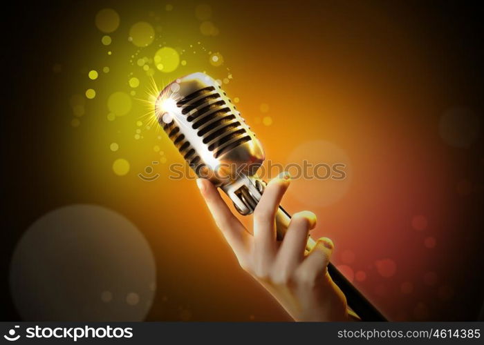 audio microphone retro style. Single retro microphone against colourful background with lights