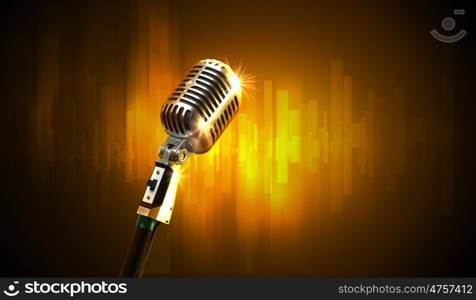 audio microphone retro style. Single retro microphone against colourful background with lights