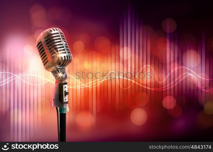 audio microphone retro style. Single retro microphone against colourful background with lights