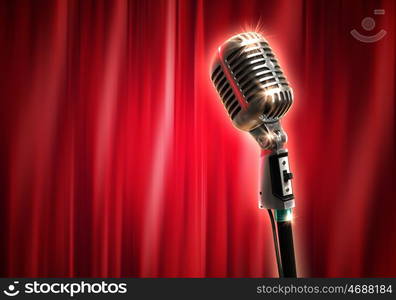 audio microphone retro style. Single retro microphone against red curtains closed on the background