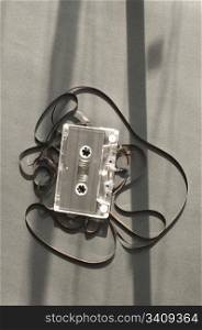 Audio tape cassette with subtracted out tape. Old broken cassette