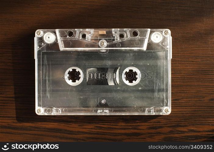 Audio tape cassette. Wooden background