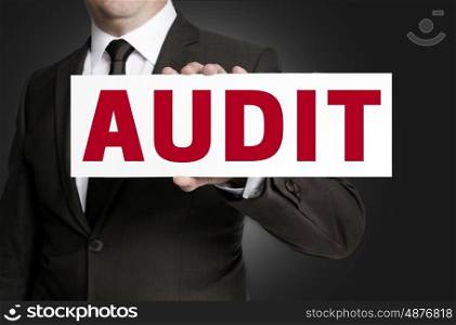 audit sign is held by businessman background. audit sign is held by businessman background.