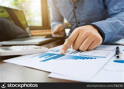 auditor or financial inspector working on sales performance report at modern workplace