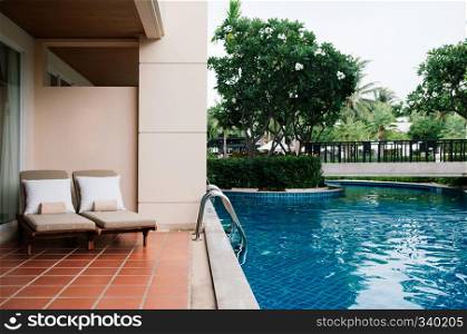 AUG 7, 2014 Hua Hin, THAILAND - Tropical resort pool beds at outdoor balcony by swimming pool in the garden