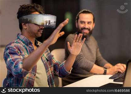 augmented reality and technology concept - developers with singapore city on virtual headset or 3d glasses screen working late at night office. developers with virtual reality headset at office