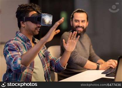 augmented reality and technology concept - developers with singapore city on virtual headset or 3d glasses screen working late at night office. developers with virtual reality headset at office. developers with virtual reality headset at office