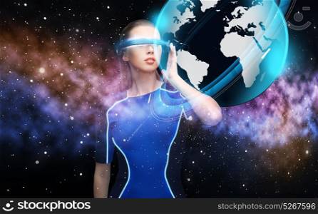 augmented reality, science, future technology and people concept - beautiful woman in futuristic 3d glasses with virtual earth projection over space background. woman in virtual reality 3d glasses with earth