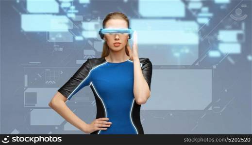 augmented reality, science, technology and people concept - beautiful woman in futuristic 3d glasses with virtual screens projection over blue background. woman in virtual reality 3d glasses with screens