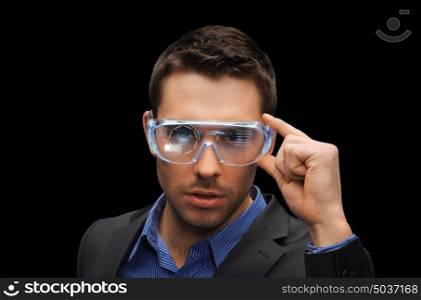 augmented reality, technology, business and people concept -businessman in virtual glasses over black background. businessman in virtual reality or 3d glasses