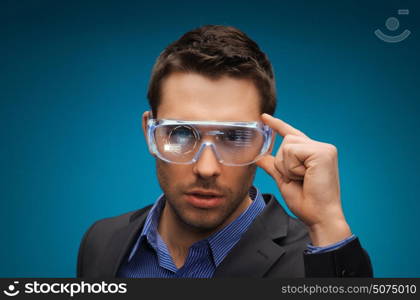 augmented reality, technology, business and people concept -businessman in virtual glasses over blue background. businessman in virtual reality or 3d glasses