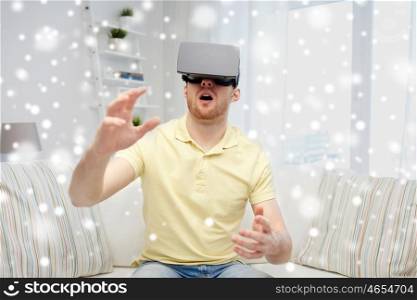 augmented reality, technology, gaming, entertainment and people concept - amazed young man with virtual headset or 3d glasses playing game over snow