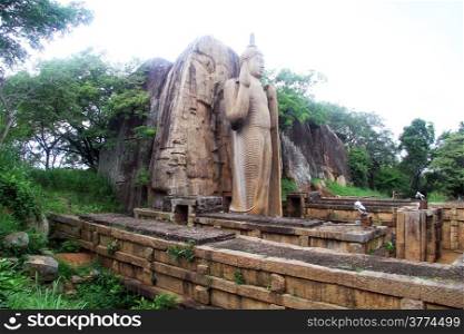 Aukana buddha and ruins of temple in Sri Lanka