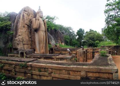 Aukana Buddha and ruins of temple in Sri Lanka