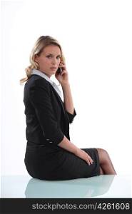 Austere businesswoman talking on her mobile phone