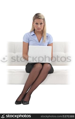 Austere woman typing on her laptop
