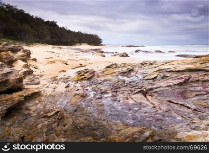 Australian ocean landscape scenic at dawn with wet rocks on Stradbroke Island