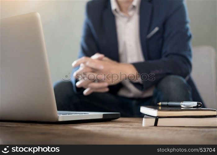 Authentic image of a pensive businessman in a coffee shop sitting in cafe and working