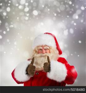 Authentic Santa Claus with real beard and great smiling giving thumb up, against snowing background with copyspace