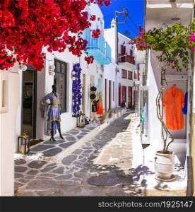 Authentic traditional Greece. Charming colorful floral streets of Mykonos island with fashion shops. Cyclades