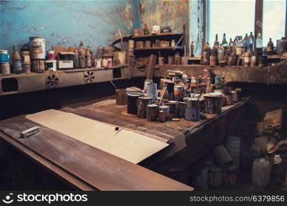 Authentic workplace for the production of furniture. shop paintwork, many paints and varnishes on background. workplace for the production of furniture